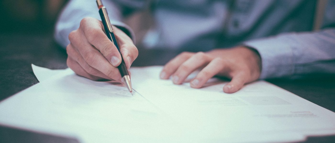 Completing an online visa application with a passport alongside